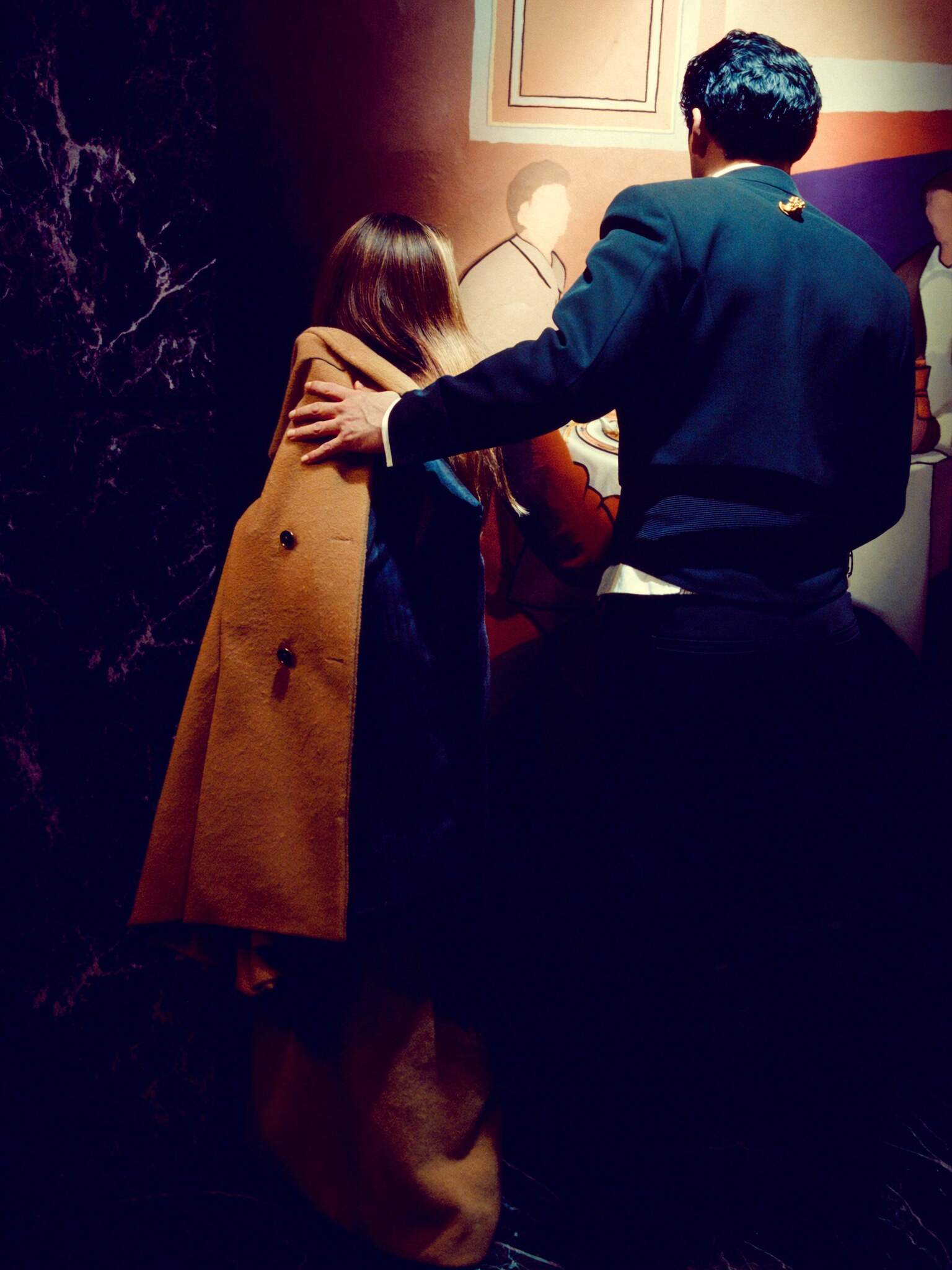 A coat taken at the door and the room opening up ahead of you.