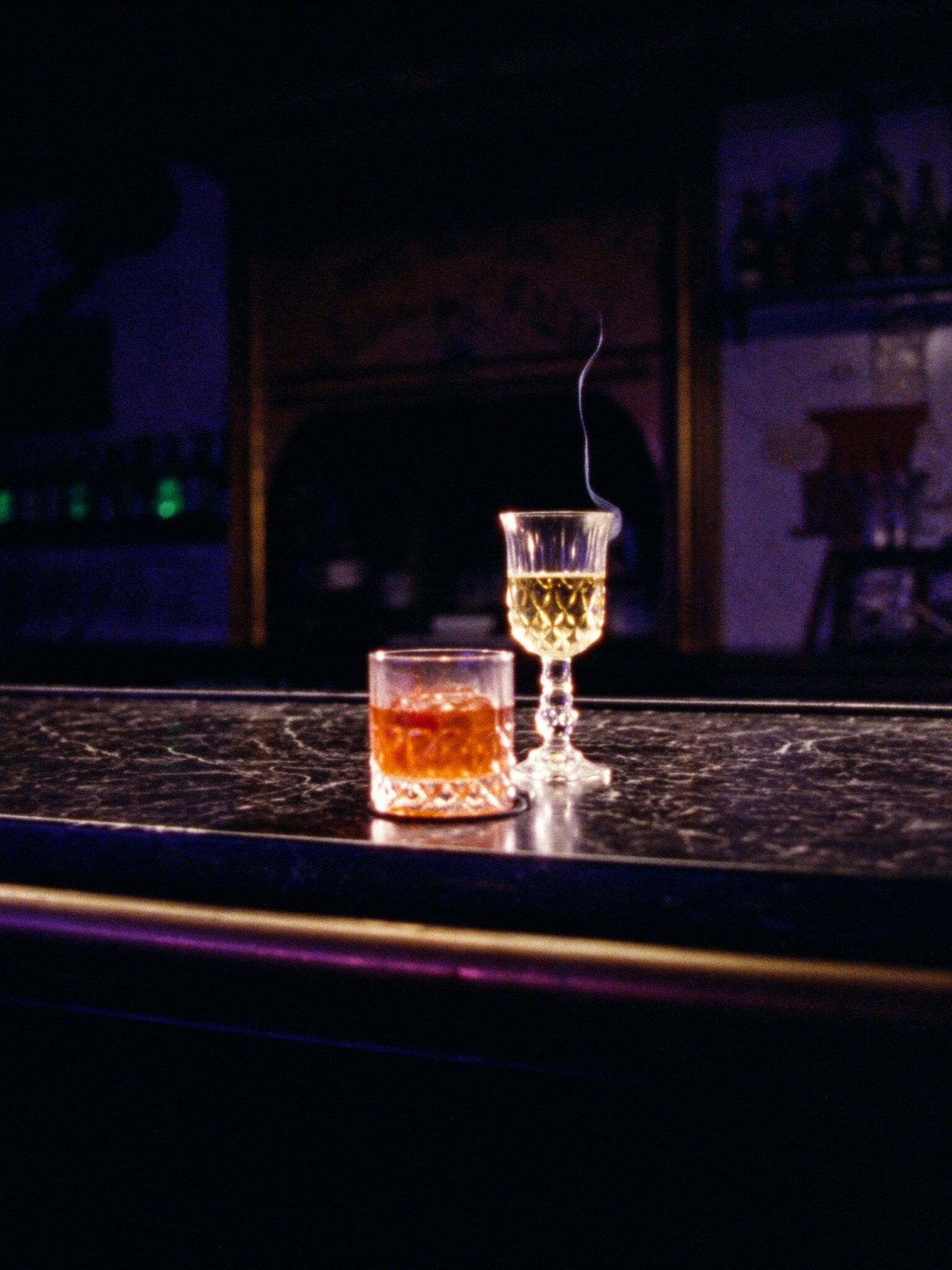 A Negroni and a coupe of grower champagne on the marble, before anyone sits down.