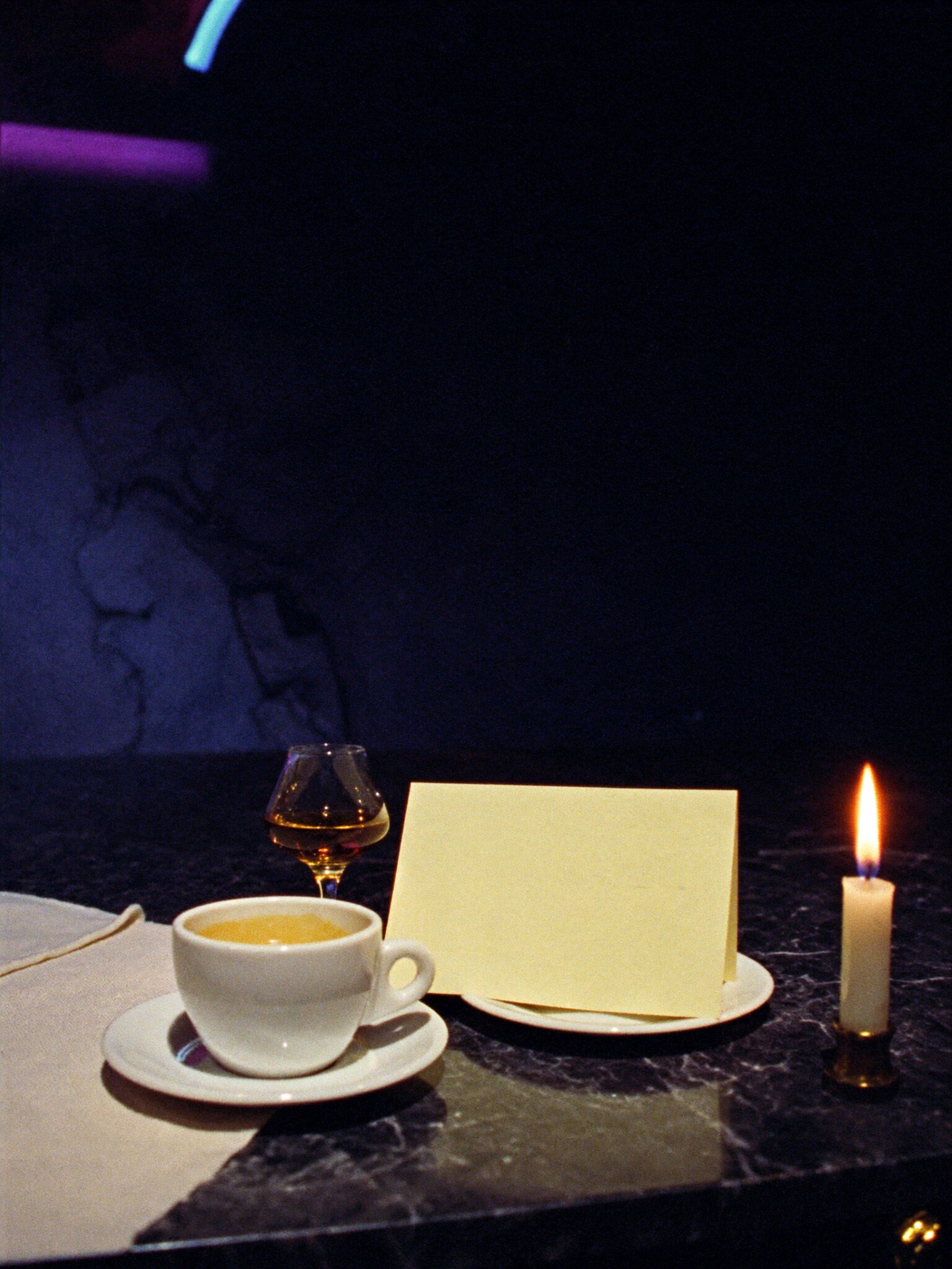 An espresso, a digestif, and a candle burning down to nothing.